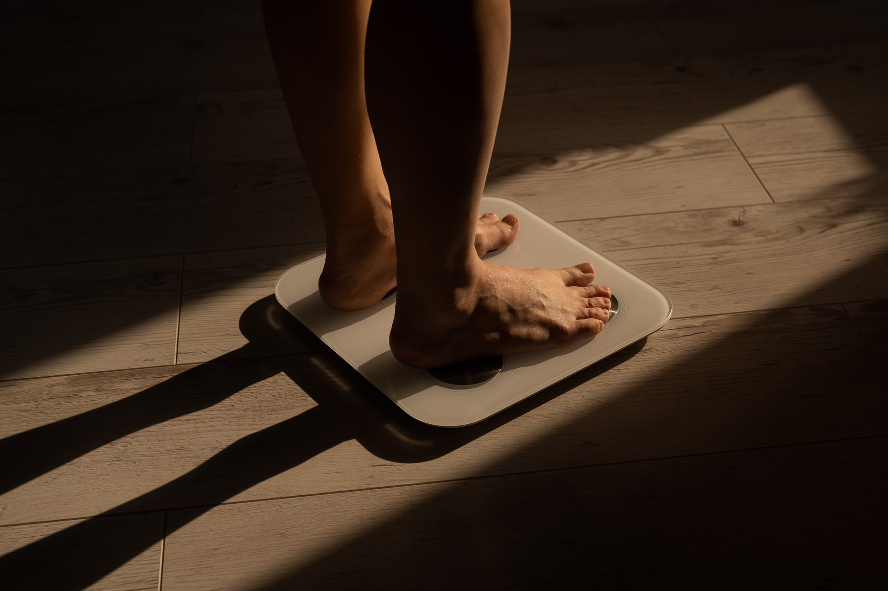 Close-up of female legs on electronic scales.